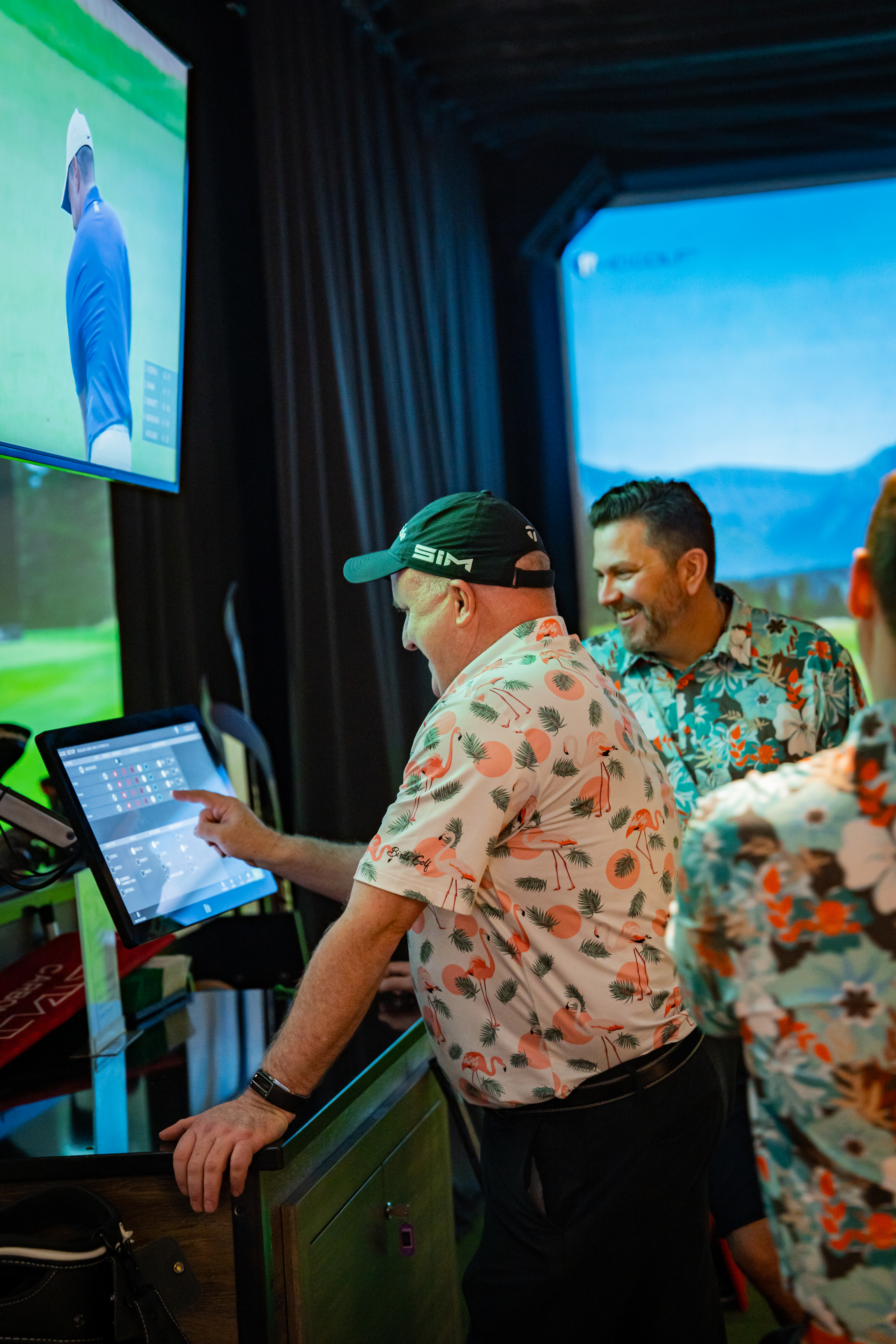 Men looking at computer screen for multi-sport simulator