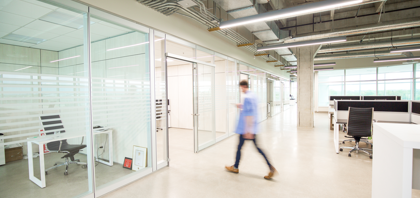 Man walking through office space