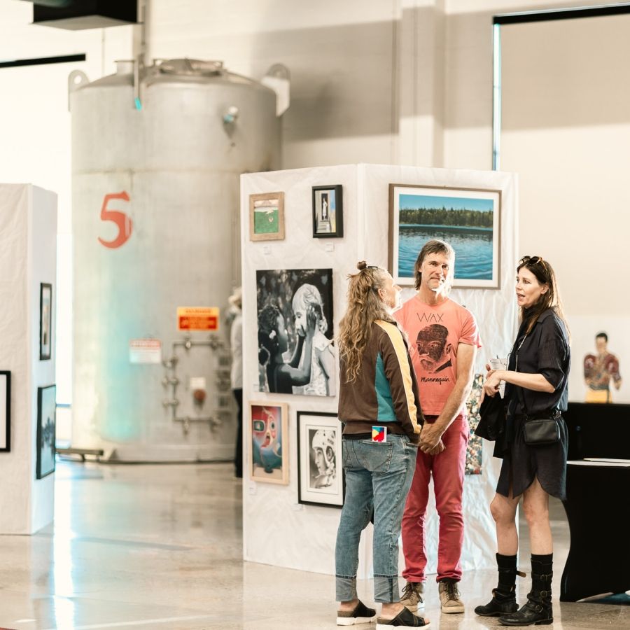 Closing Ceremonies Art Show Guests viewing and talking at the closing ceremony art show.