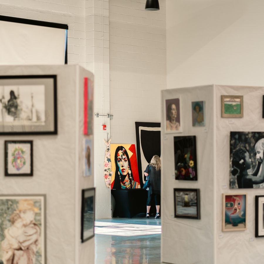 Art Comp Art Show Many walls covered in artwork at the end of show art gallery.